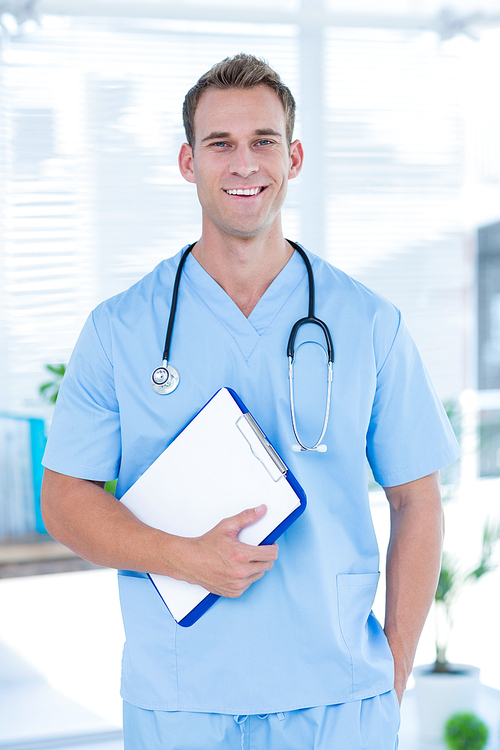 Portrait of a smiling doctor holding a clipboard