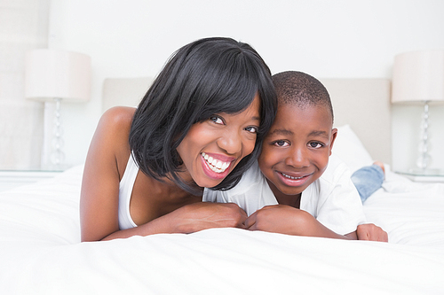 Portrait of a pretty mother with his son in bed at home in bedroom