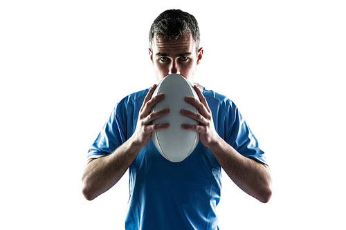 Portrait of a serious rugby player holding a rugby ball