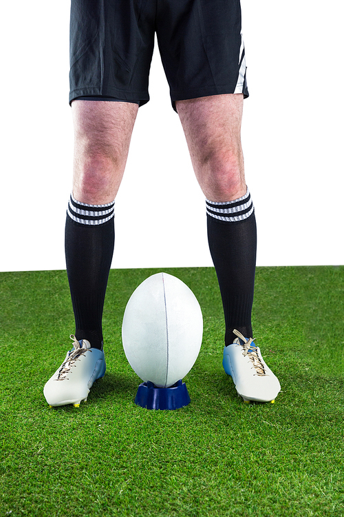 Low angle view of a rugby player ready to make a drop kick