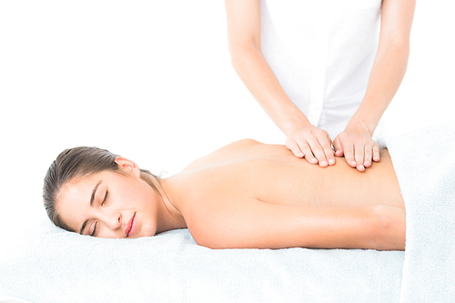 Beautiful brunette enjoying a massage at the health spa