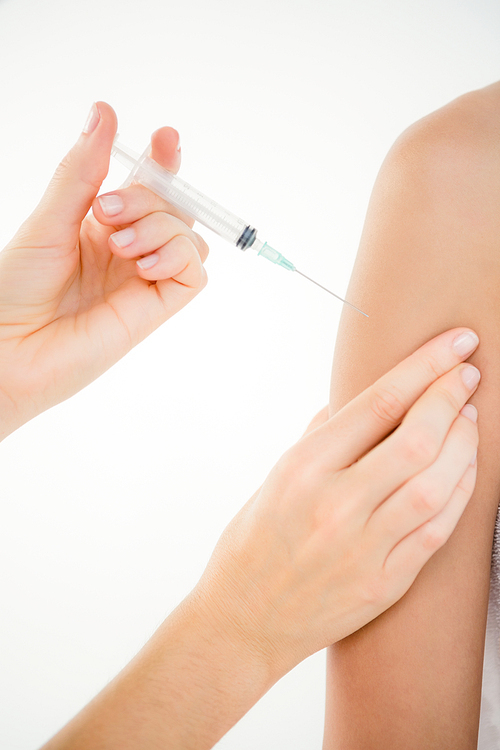 Doctor doing an injection to his patient in medical office