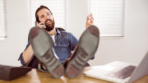 Hipster businessman on a call in his office