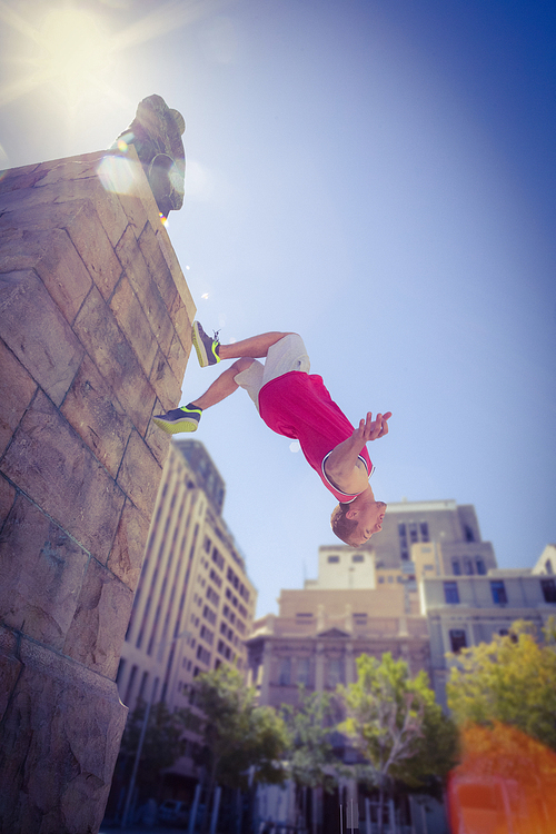 Happy man doing parkour on a sunny day