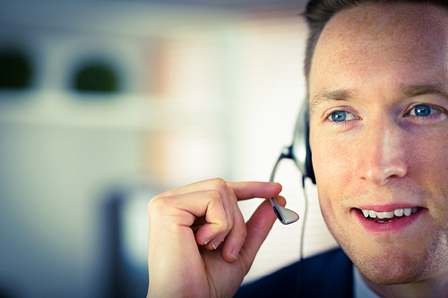 Happy call center agent working in his office