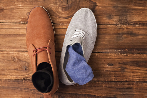 Casual and dressy mens shoes on wooden table