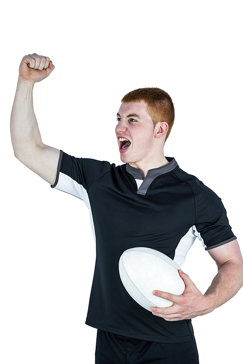 Rugby player gesturing victory while holding a rugby ball
