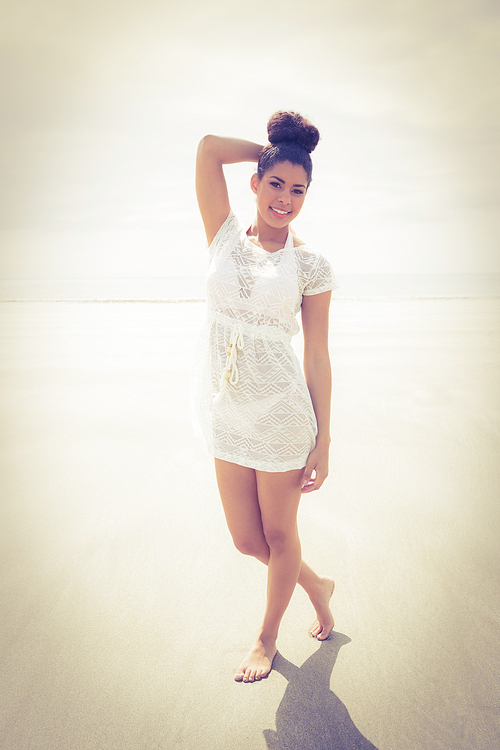 Stylish girl posing on the sand at the beach