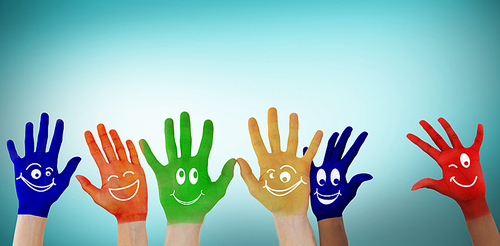 Hands with colourful smiley faces against blue vignette background