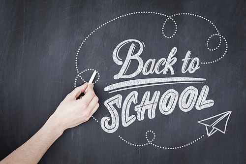 back to school against hand writing with chalk on board