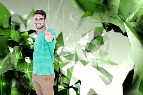 Portrait of smiling handsome man gesturing thumbs up against angular design