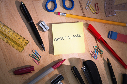 The word group classes against students table with school supplies