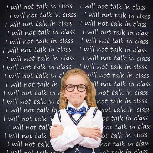 Cute pupil with arms crossed against blackboard
