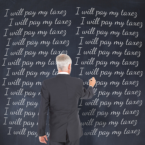 Rear view of businessman standing and writing against black background