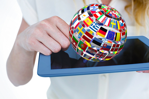 Woman using tablet pc  against sphere made of flags