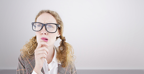 Composite image of geeky hipster woman thinking with hand on chin