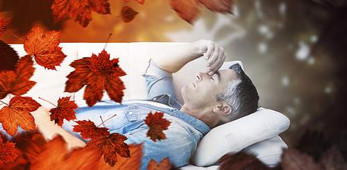 Composite image of man suffering from headache while on sofa