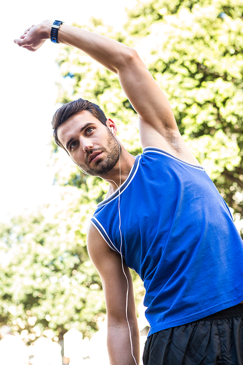 Handsome athlete stretching in the city