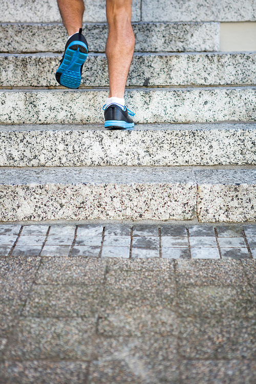 Athlete jogging up the stairs in the city