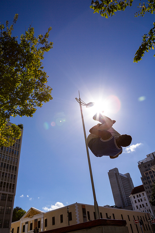 Man doing parkour in the city on a sunny day