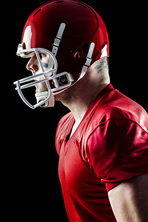 American football player side profile on black background
