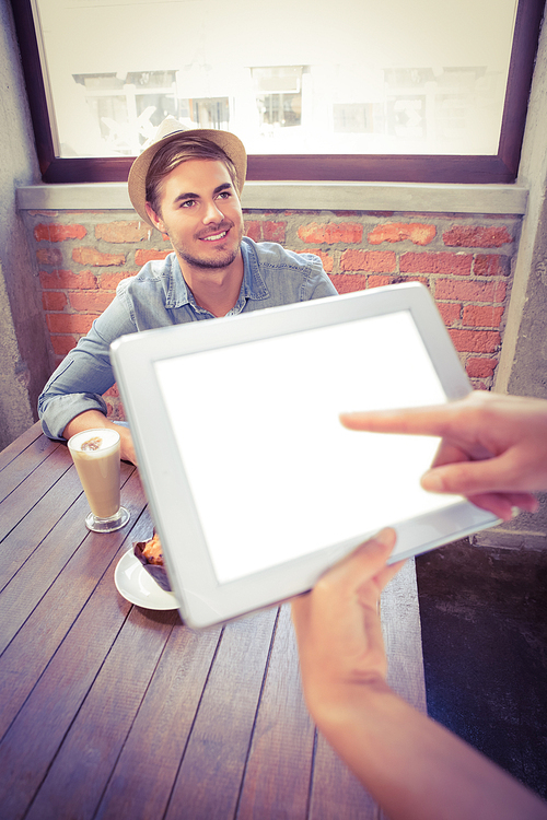 Waitress taking handsome hipsters order with tablet at coffee shop