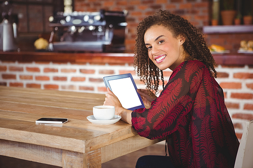 Woman using digital tablet in a cafe