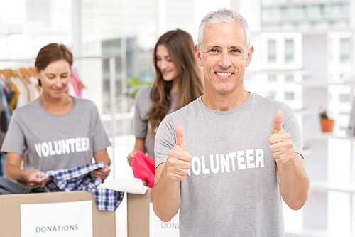 Portrait of smiling volunteer doing thumbs up in the office