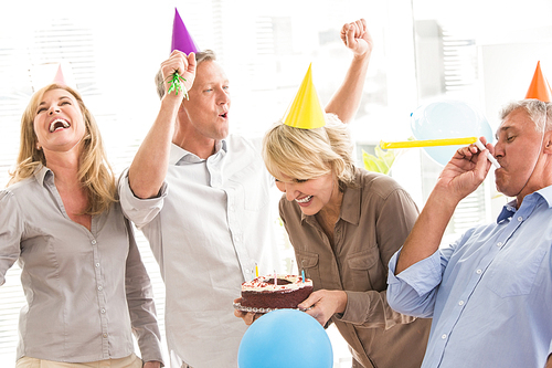 Casual business people celebrating birthday and having fun in the office