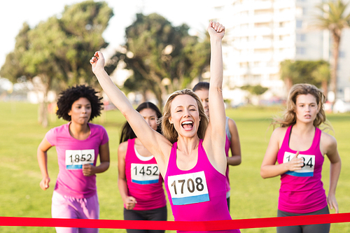 Cheering blonde winning breast cancer marathon in parkland