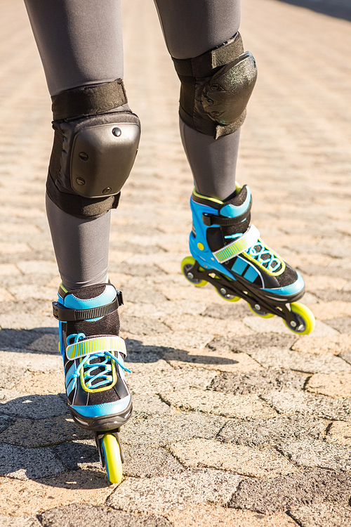 Close up view of inline skates skating at promenade