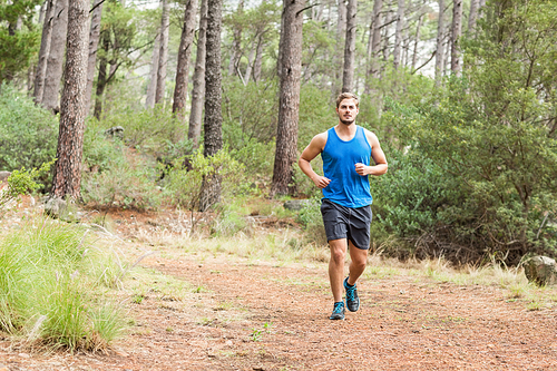 Young happy jogger running in the nature