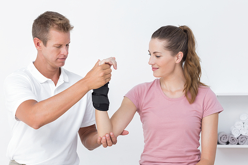 Doctor examining a woman wrist in medical office