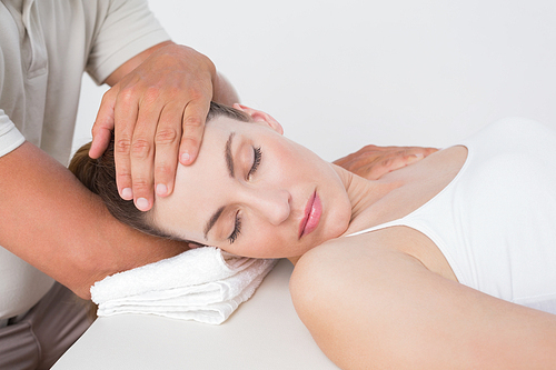 Woman receiving neck massage in medical office
