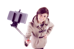 Attractive woman taking a selfie with a selfie stick