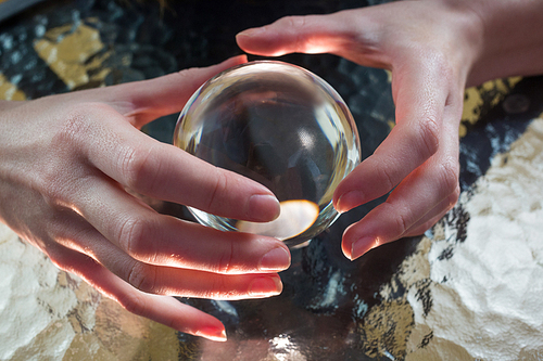 Fortune teller using crystal ball high angle view
