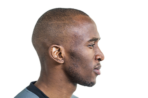 Profile view of confident sportsman against white background