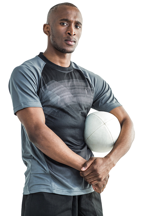 Portrait of confident sportsman with rugby ball standing against white background