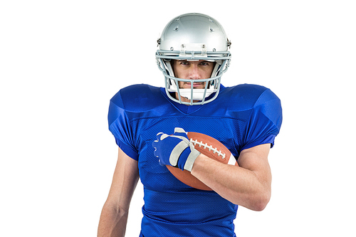 Portrait of American football player holding ball against white background