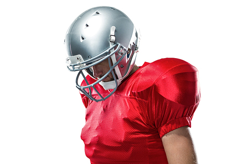 American football player in red jersey looking down against white background