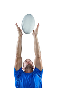 Rugby player catching ball against white background