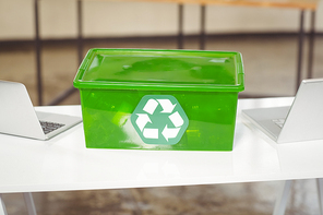 High angle view of recycling box amidst laptop on table