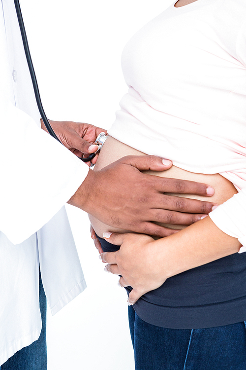 Midsection doctor checking pregnant woman against white background