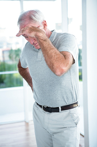 Mature depressed man standing at home