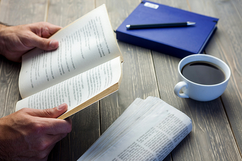 Person reading book at the desk