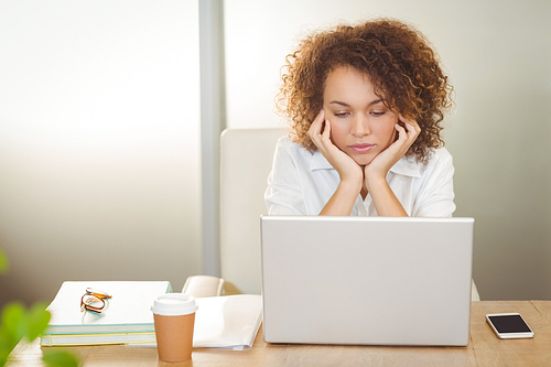 Businesswoman with hand on chin