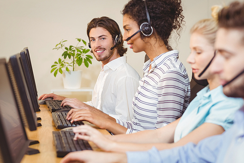 Portrait of smiling executive in call center