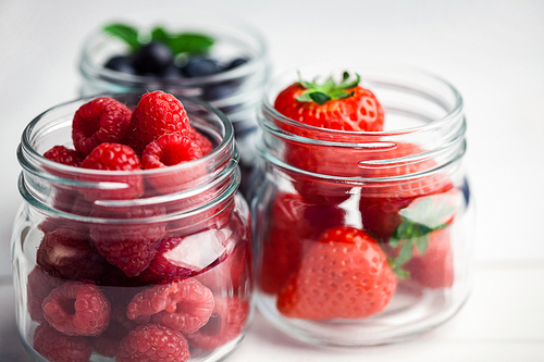 Glass jars of fresh berries