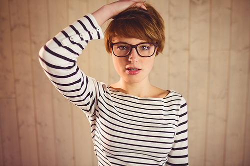 Pretty young woman with hand in hair