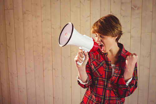 Pretty young woman using megaphone